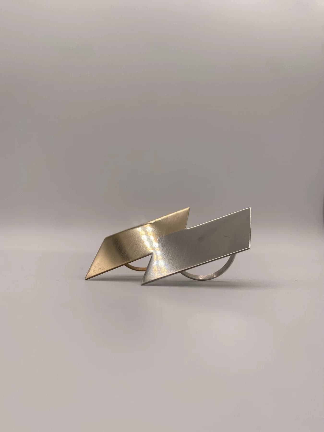 Close view of angular metal forms resting together.