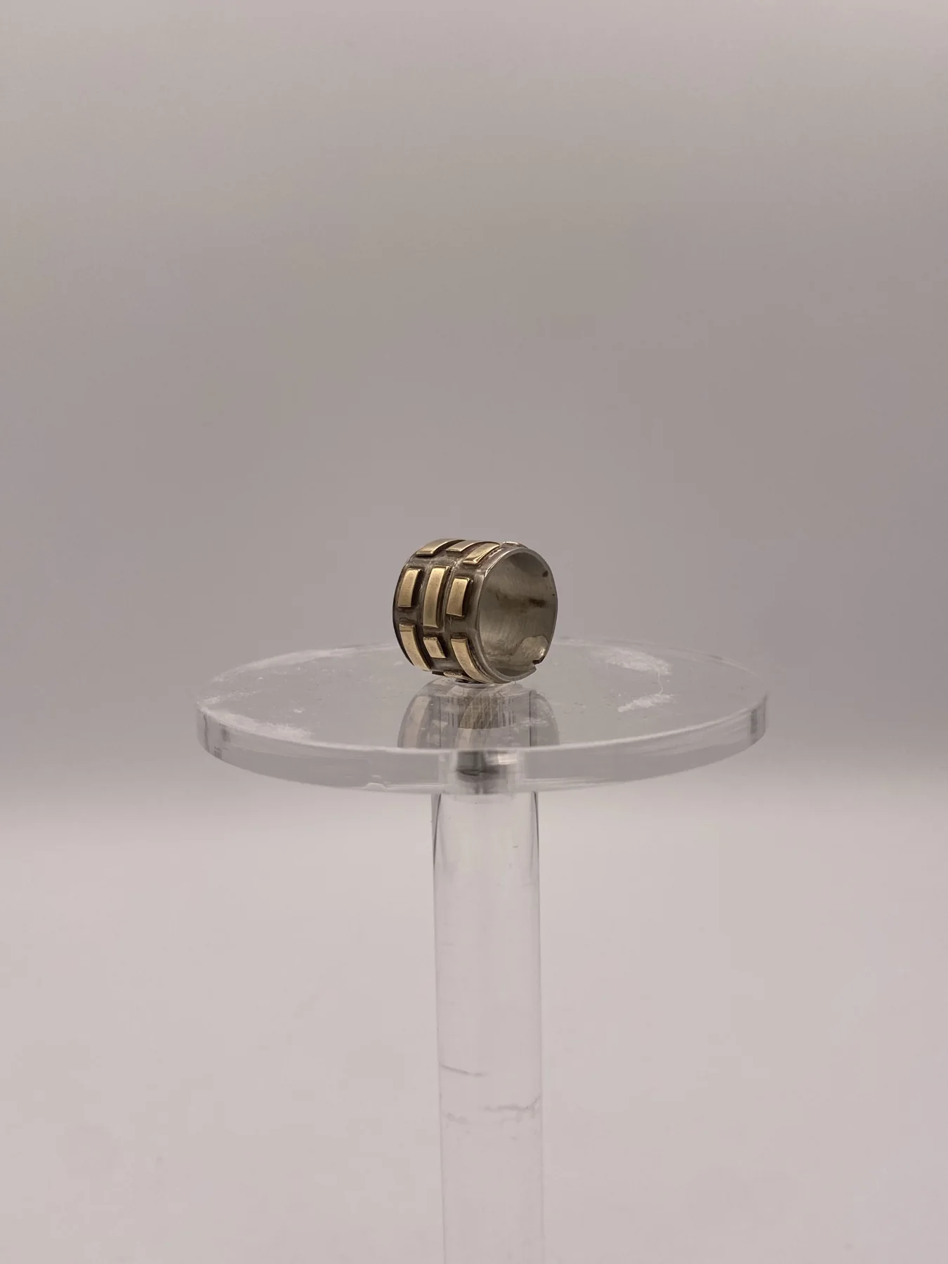 Rounded ring shown from the front on a clear stand.