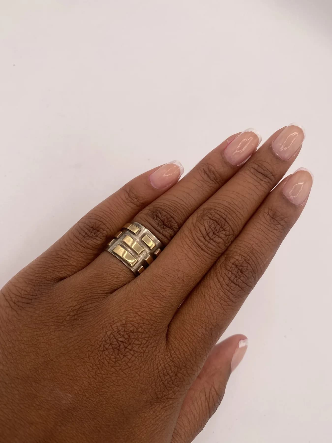 A set of stacked rings worn on a hand.